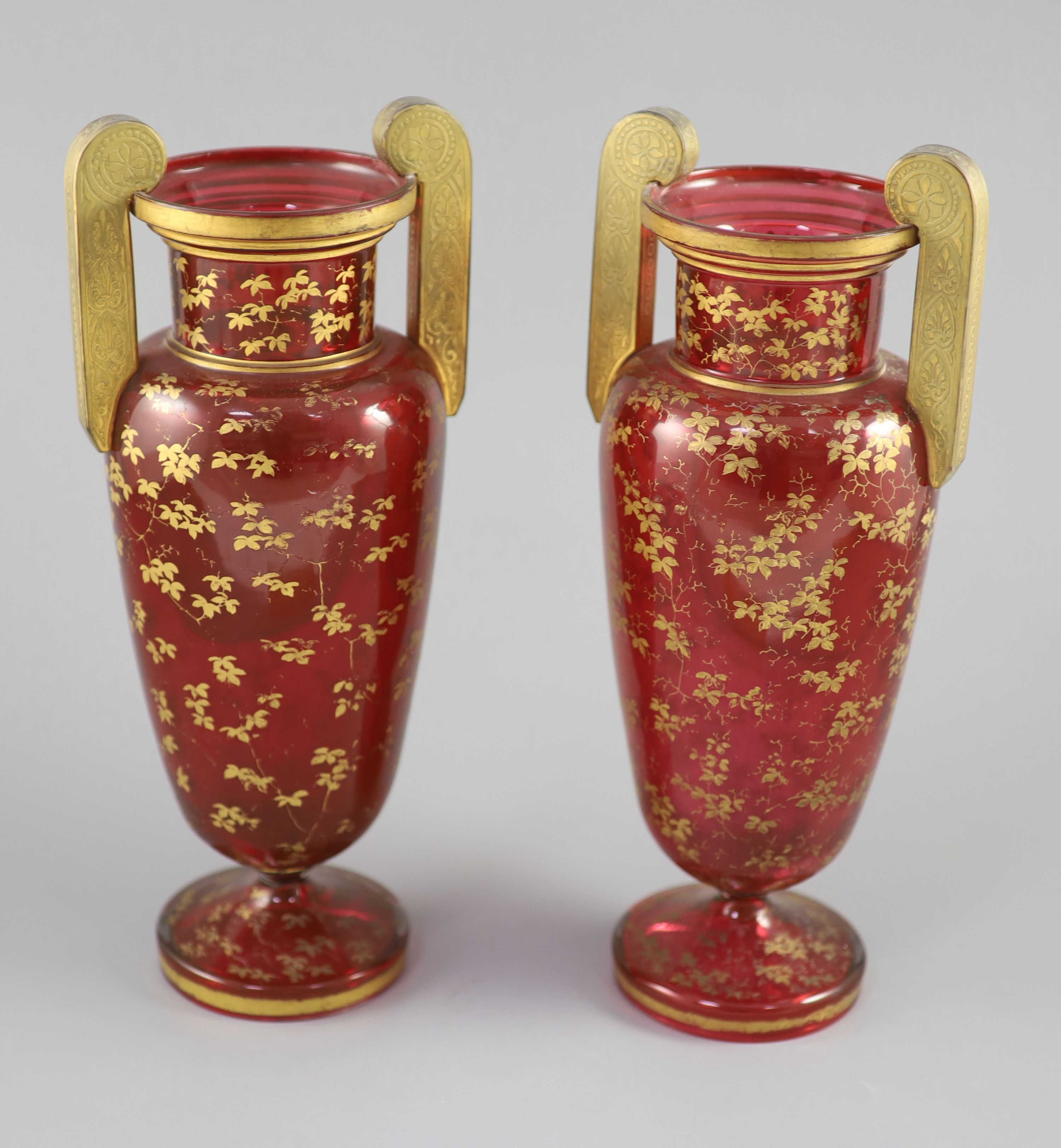 A pair of Bohemian gilt decorated ruby glass two handled vases, late 19th century, height 32cm